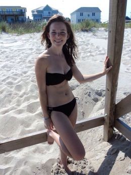 Funny girl in a bikini on the beach